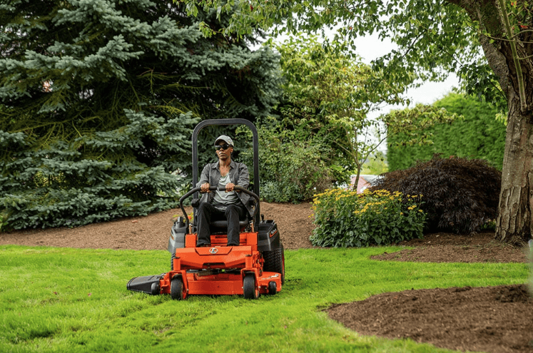 Woman mowing her lawn with mower
