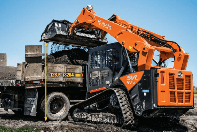 Track loader dumping into the back of truck bed