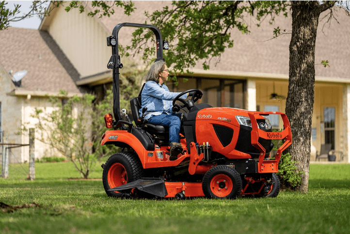 Woman driving a sub-compact tractor