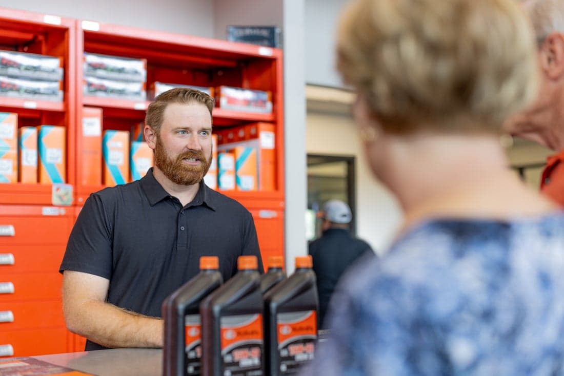 Parts employee consulting with customers